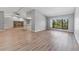 Open-concept living space with modern floors, large windows, and a stone fireplace feature at 3334 Pineview Dr, Holiday, FL 34691