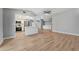 Spacious open-plan living room features wood floors, a kitchen island, and stone fireplace at 3334 Pineview Dr, Holiday, FL 34691