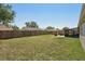 Expansive and grassy backyard with a screened lanai, paver patio and perimeter fence at 3410 5Th W Dr, Palmetto, FL 34221