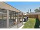 A partially enclosed patio and a backyard with a grill and green grass at 3410 5Th W Dr, Palmetto, FL 34221