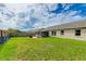 Large backyard with a patio, fire pit, and hammock next to the screened in lanai at 3410 5Th W Dr, Palmetto, FL 34221