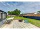 A relaxing backyard space offering a hammock, fire pit, paver patio, and serene landscaping at 3410 5Th W Dr, Palmetto, FL 34221