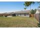 Large grassy backyard with a screened lanai, paver patio, and private fenced perimeter at 3410 5Th W Dr, Palmetto, FL 34221