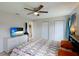 Bright bedroom featuring tile flooring, ceiling fan, a TV and closet at 3410 5Th W Dr, Palmetto, FL 34221
