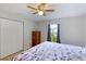 A bright bedroom with a closet, window with grey curtains, and a wood dresser at 3410 5Th W Dr, Palmetto, FL 34221