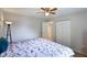This bedroom features a ceiling fan, tile flooring, and a double closet at 3410 5Th W Dr, Palmetto, FL 34221