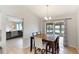 Cozy dining room with wood table set, chandelier, and sliding door access to the backyard at 3410 5Th W Dr, Palmetto, FL 34221