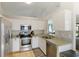This kitchen features stainless steel appliances, white cabinetry, and granite countertops at 3410 5Th W Dr, Palmetto, FL 34221