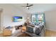 Bright living room featuring a large sectional sofa, ceiling fan, and windows providing natural light, creating a cozy atmosphere at 3410 5Th W Dr, Palmetto, FL 34221