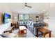 Comfortable living room featuring a plush sectional sofa, large windows, and modern ceiling fan for relaxed living at 3410 5Th W Dr, Palmetto, FL 34221