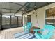 Enclosed sunroom features seating for two and a view of the yard at 3410 5Th W Dr, Palmetto, FL 34221