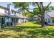 Spacious backyard with lush green grass and mature trees providing ample shade and a relaxing outdoor space at 4146 Brentwood Park Cir, Tampa, FL 33624