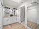 Stylish bathroom featuring double sinks, modern fixtures, wood flooring, and a large framed mirror at 4146 Brentwood Park Cir, Tampa, FL 33624