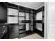 Well-organized walk-in closet with black shelving and drawers for ample storage space at 4146 Brentwood Park Cir, Tampa, FL 33624