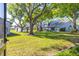 Serene view of the building exterior overlooking a well-maintained lawn and a pond with fountain at 4146 Brentwood Park Cir, Tampa, FL 33624