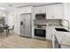 Modern kitchen with stainless steel appliances, white cabinets, and breakfast nook at 4146 Brentwood Park Cir, Tampa, FL 33624