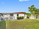 Spacious backyard features lush lawn, white picket fence, landscaping, and covered parking at 4532 W Idlewild Ave, Tampa, FL 33614