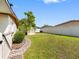Well-maintained backyard with lush lawn, white vinyl fence, and charming stone pathway at 4532 W Idlewild Ave, Tampa, FL 33614