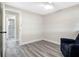 Bedroom featuring gray wood-look floors, a chair, and a bathroom at 4532 W Idlewild Ave, Tampa, FL 33614