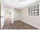 Bedroom featuring gray wood-look floors, a closet, and natural light from a window at 4532 W Idlewild Ave, Tampa, FL 33614