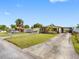 Attractive home featuring a well-manicured front yard and long driveway on corner lot at 4532 W Idlewild Ave, Tampa, FL 33614