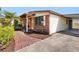 Charming home with brick accents, a covered porch, and manicured landscaping at 4532 W Idlewild Ave, Tampa, FL 33614