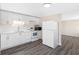 Modern kitchen featuring white cabinets and stainless steel appliances with vinyl flooring and a bright light at 4532 W Idlewild Ave, Tampa, FL 33614