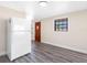 Kitchen with wood floors, white cabinets, view of the front entry and stainless steel refrigerator at 4532 W Idlewild Ave, Tampa, FL 33614
