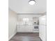 Modern kitchen featuring white cabinets, and stainless steel appliances with new light fixture at 4532 W Idlewild Ave, Tampa, FL 33614