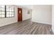 Bright and spacious living room with wood floors, windows and view of the front entry door at 4532 W Idlewild Ave, Tampa, FL 33614