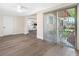 Bright living room with wood floors, view of the kitchen and sliding doors to outdoor seating at 4532 W Idlewild Ave, Tampa, FL 33614