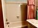 Clean bathroom featuring a tiled bathtub and shower, plus vanity with countertop at 4558 Blossom Blvd # D, Zephyrhills, FL 33542
