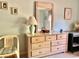 Bright bedroom featuring a dresser with mirror, accompanied by a chair and desk at 4558 Blossom Blvd # D, Zephyrhills, FL 33542