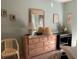 Bedroom features a dresser, lamp, and decorative accents, creating a cozy and inviting atmosphere at 4558 Blossom Blvd # D, Zephyrhills, FL 33542
