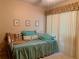 Bedroom with throw pillows, a light green comforter and a blanket on daybed at 4558 Blossom Blvd # D, Zephyrhills, FL 33542
