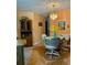 Dining area has a table with chairs, a crystal chandelier, and a wooden cabinet at 4558 Blossom Blvd # D, Zephyrhills, FL 33542