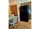Dining area features a black refrigerator, a table with colorful tablecloth, and closet at 4558 Blossom Blvd # D, Zephyrhills, FL 33542