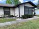 Single-story home with manicured landscaping, neutral exterior paint, and a sidewalk at 4558 Blossom Blvd # D, Zephyrhills, FL 33542