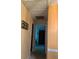 Hallway with paintings on wall and view of bedrooms at 4558 Blossom Blvd # D, Zephyrhills, FL 33542