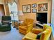 Spacious living room with seating area with yellow armchairs and a green recliner at 4558 Blossom Blvd # D, Zephyrhills, FL 33542