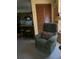 Inviting living space featuring a comfortable armchair and a view of the kitchen at 4558 Blossom Blvd # D, Zephyrhills, FL 33542