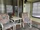 Enclosed outdoor patio featuring comfortable seating with floral cushions, and a small table at 4558 Blossom Blvd # D, Zephyrhills, FL 33542