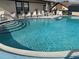 Community pool with lounge chairs provides a great outdoor space to enjoy the Florida sun at 4558 Blossom Blvd # D, Zephyrhills, FL 33542