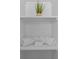 Brightly lit bathroom shelf stocked with fresh, rolled white towels at 4715 Kemble Ct, Tampa, FL 33624