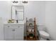 Bathroom with single vanity, modern lighting, and shelving for storage at 4715 Kemble Ct, Tampa, FL 33624