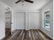 Bedroom with wood-look floors, two closets, and natural light from the window at 4715 Kemble Ct, Tampa, FL 33624