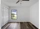 Bedroom with wood-look floors, closet, and natural light from the backyard window at 4715 Kemble Ct, Tampa, FL 33624