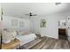 Bright bedroom with wood-look floors, ceiling fan, and an ensuite bathroom at 4715 Kemble Ct, Tampa, FL 33624
