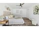Bright bedroom with wood-look floors, ceiling fan, and neutral decor at 4715 Kemble Ct, Tampa, FL 33624