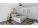 Serene bedroom featuring neutral colors, wood-look floors, and a ceiling fan at 4715 Kemble Ct, Tampa, FL 33624
